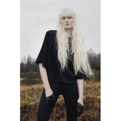 Blonde woman in rural landscape.png